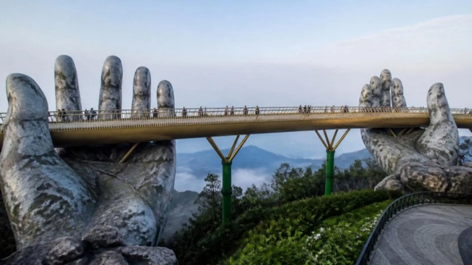 Golden Bridge held by stone hands above the clouds