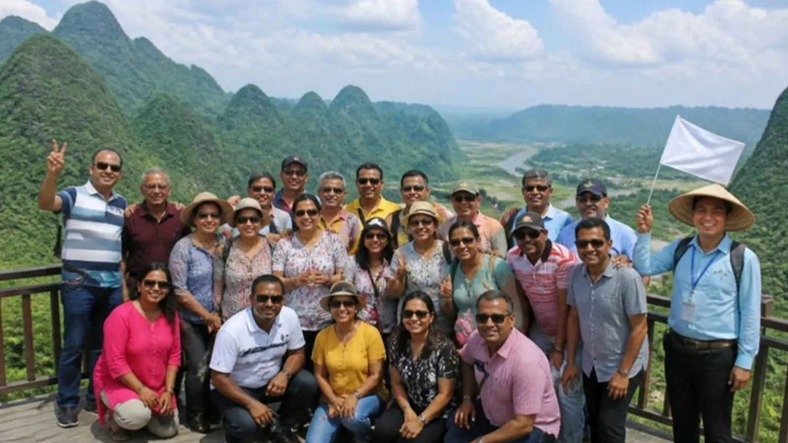 Group posing at a viewpoint with a guide flag
